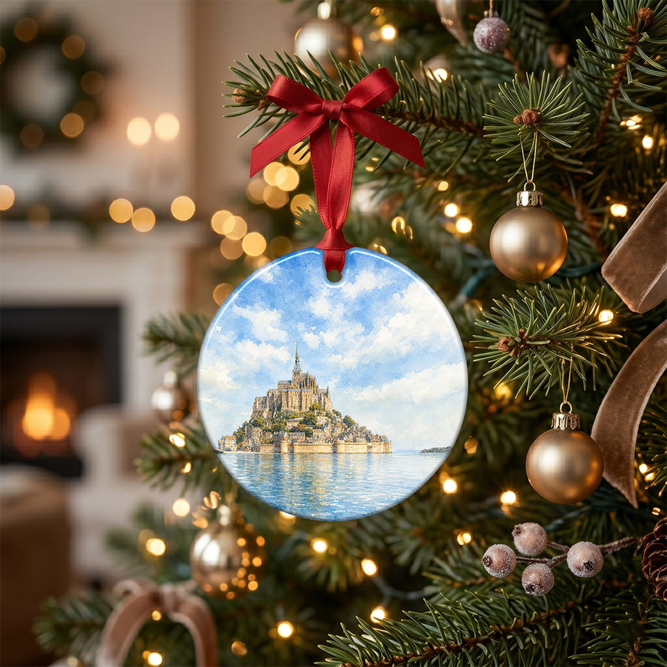 Holiday ceramic keepsake hanging on a lit Christmas tree branch with festive lights.