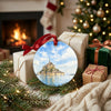 Normandy travel souvenir placed next to wrapped gifts beside a warm hearth.