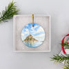 Packaged France souvenir ornament resting inside an open white gift box ready to give.
