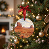 Ceramic travel keepsake hanging on a warm lit holiday tree branch.