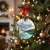 Ceramic Canadian Rockies holiday keepsake hanging gently from a lit Christmas tree branch