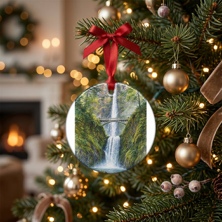 Festive holiday display showing the waterfall ornament on a table alongside pinecones and a candle.