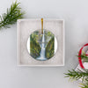 Pacific Northwest scenic ornament presented neatly inside an opened white gift box.