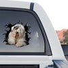 Glossy Old English Sheepdog decal adhered to the rear window of a truck outdoors.