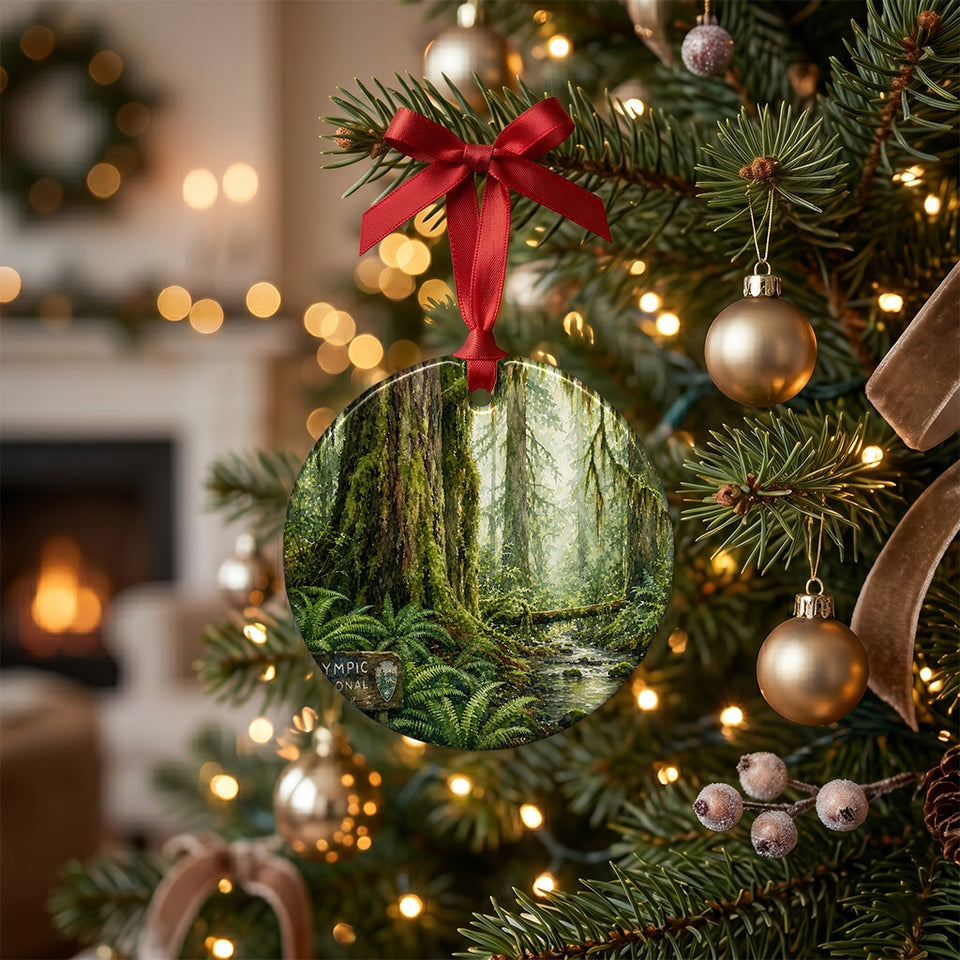 Lush Olympic National Park holiday keepsake hanging from a warm, illuminated Christmas tree branch.