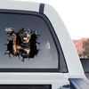 Cute Rottweiler window decal displayed on the back glass of a truck outdoors.