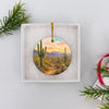 Ceramic Saguaro National Park travel ornament nestled neatly inside an opened white gift box.