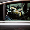A realistic sea turtle decal decorates the exterior smooth surface of a car door.