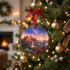 Holiday ornament with starry desert buttes hanging from an illuminated Christmas tree branch.