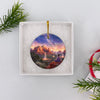Packaged travel ornament nestled neatly inside an open white gift box ready for giving.