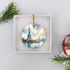 Lady Liberty Christmas ornament resting inside an open gift box prepared for festive giving.
