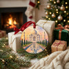 India travel holiday ornament resting beside wrapped gifts near a glowing living room fireplace.
