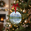 Grand Teton holiday decoration hanging gracefully from an evergreen Christmas tree branch