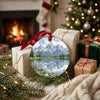 Wyoming mountain keepsake ornament resting near holiday gifts beside a warm, glowing fireplace
