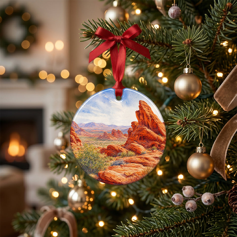 Desert landscape holiday ornament hanging on a glowing Christmas tree.