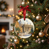 Ceramic Vatican City keepsake hanging gracefully from a lit pine branch on a Christmas tree.