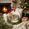 Holiday ornament showing Vatican architecture nestled beside wrapped gifts and a warm hearth.