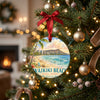 Tropical Oahu holiday ornament hanging from an illuminated branch on a Christmas tree.