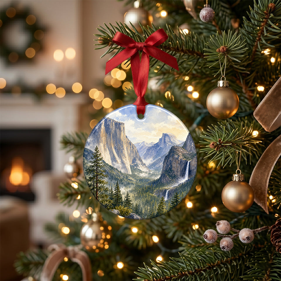 Round Yosemite keepsake hanging gracefully from an evergreen holiday tree branch.